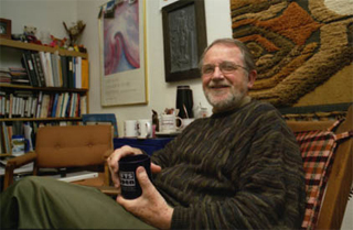 Gary Hesser sitting comfortably in his messy office